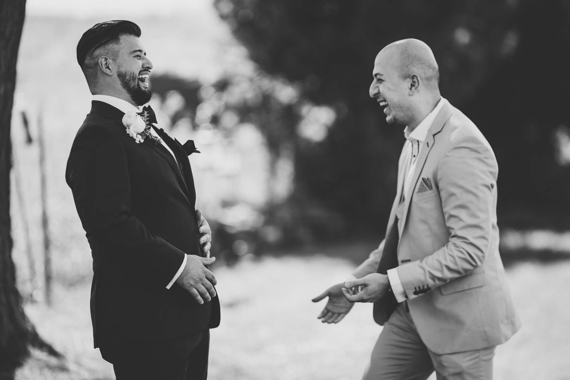 groom and his best friend laughing together