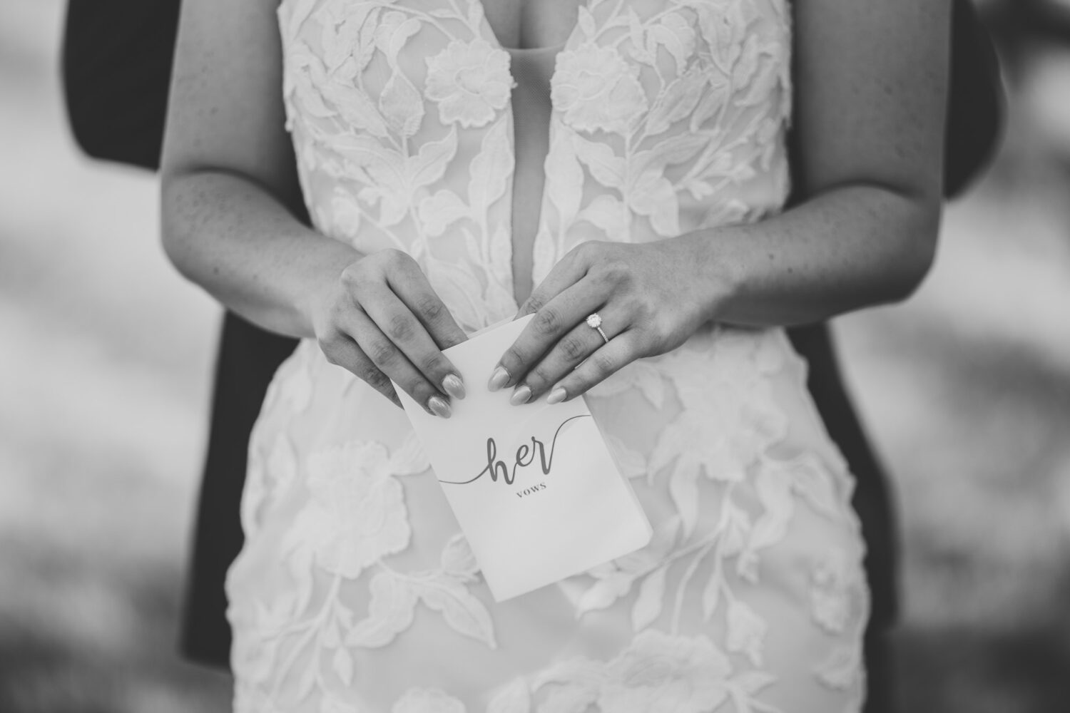 detail photo of the bride holding her vow book