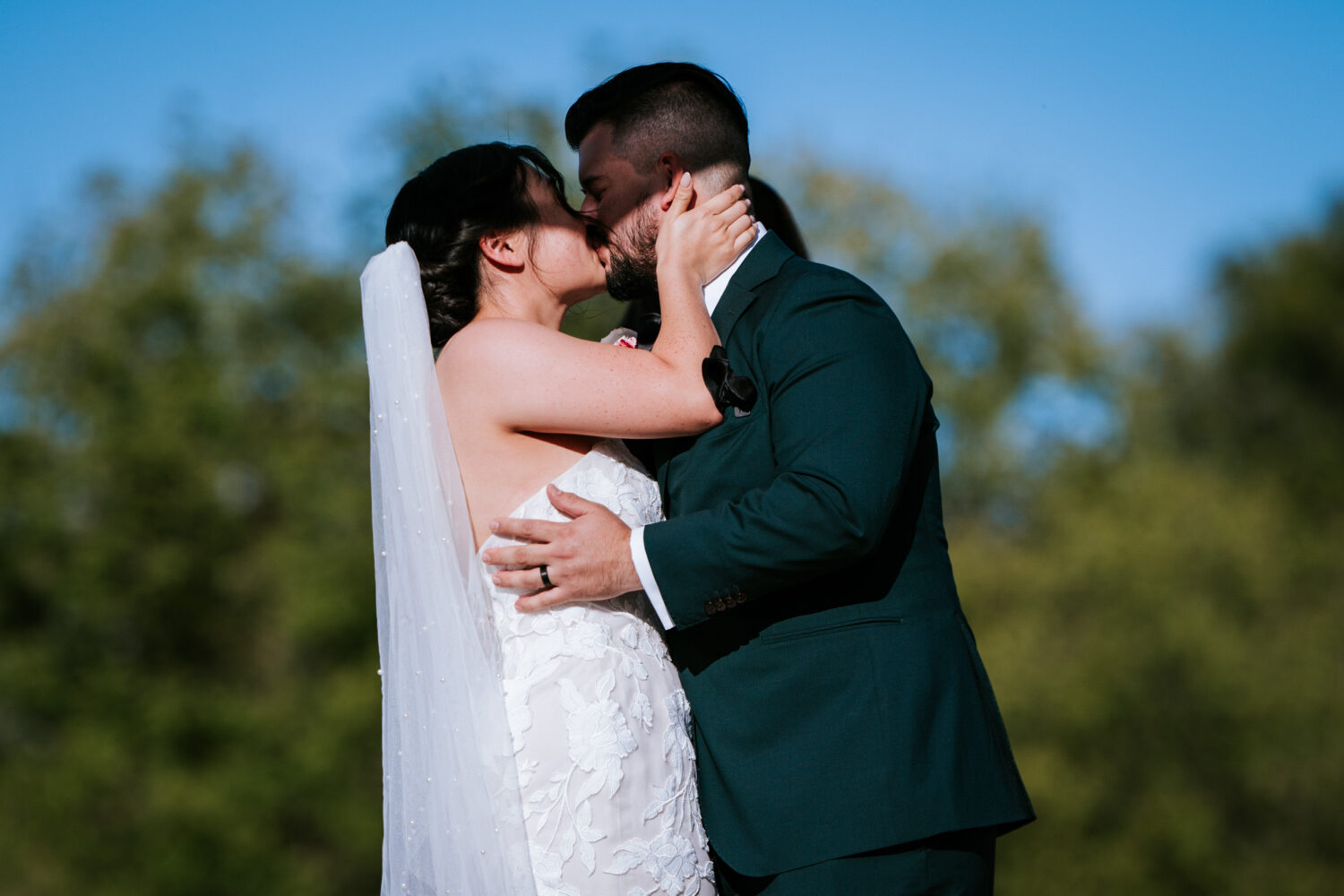 bride and groom share a first kiss at their wedding ceremony