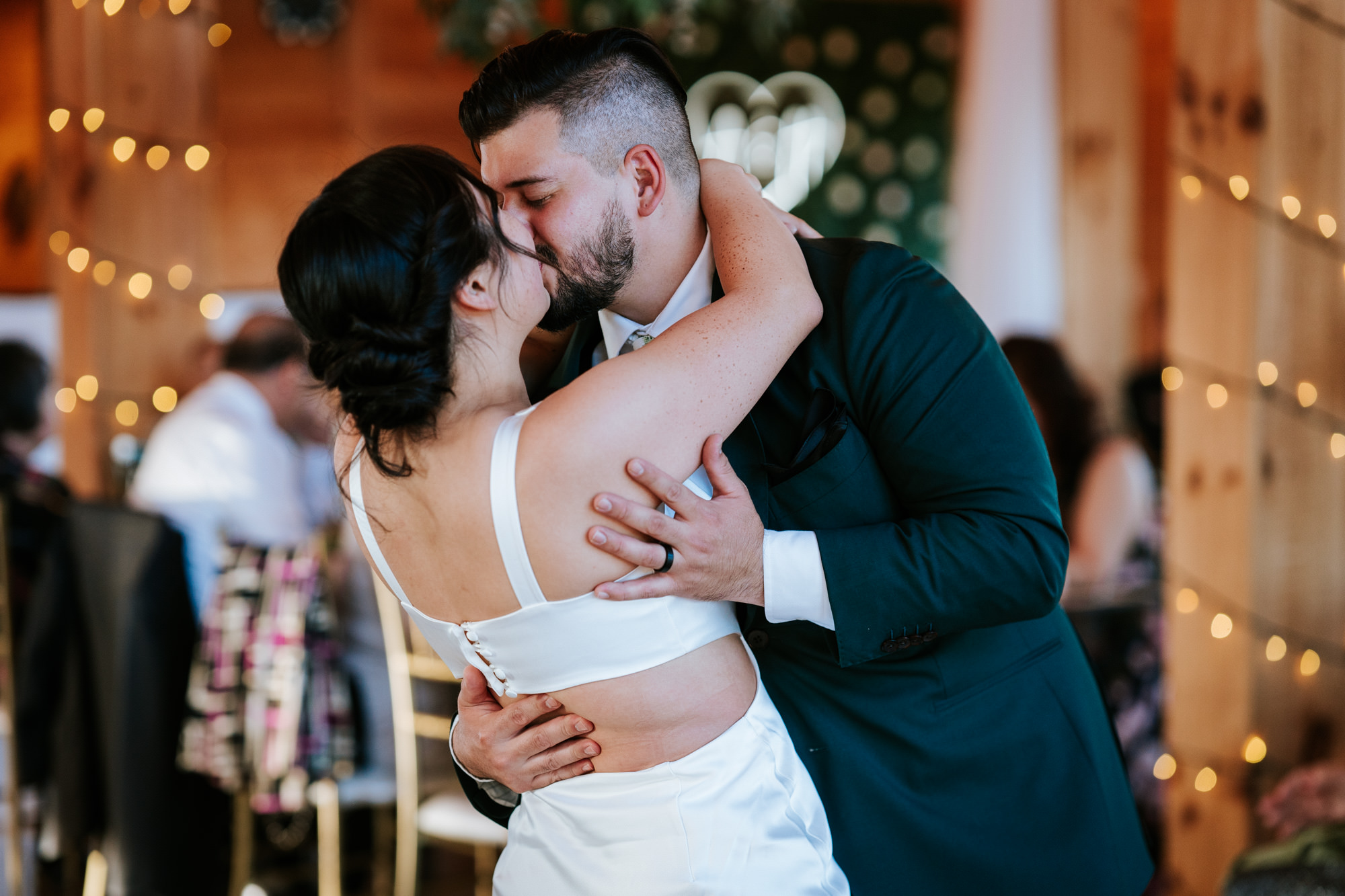 bride and groom kissing after their first dance finished