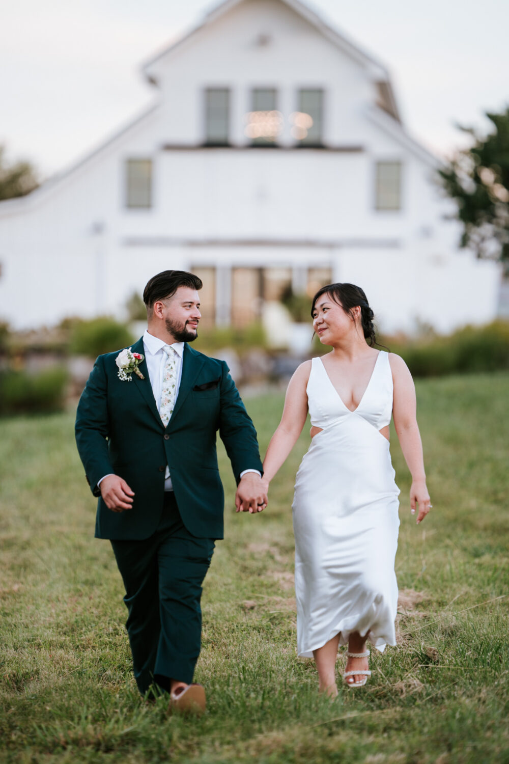 bride and groom walking together during their willow brook wedding day in leesburg, virginia