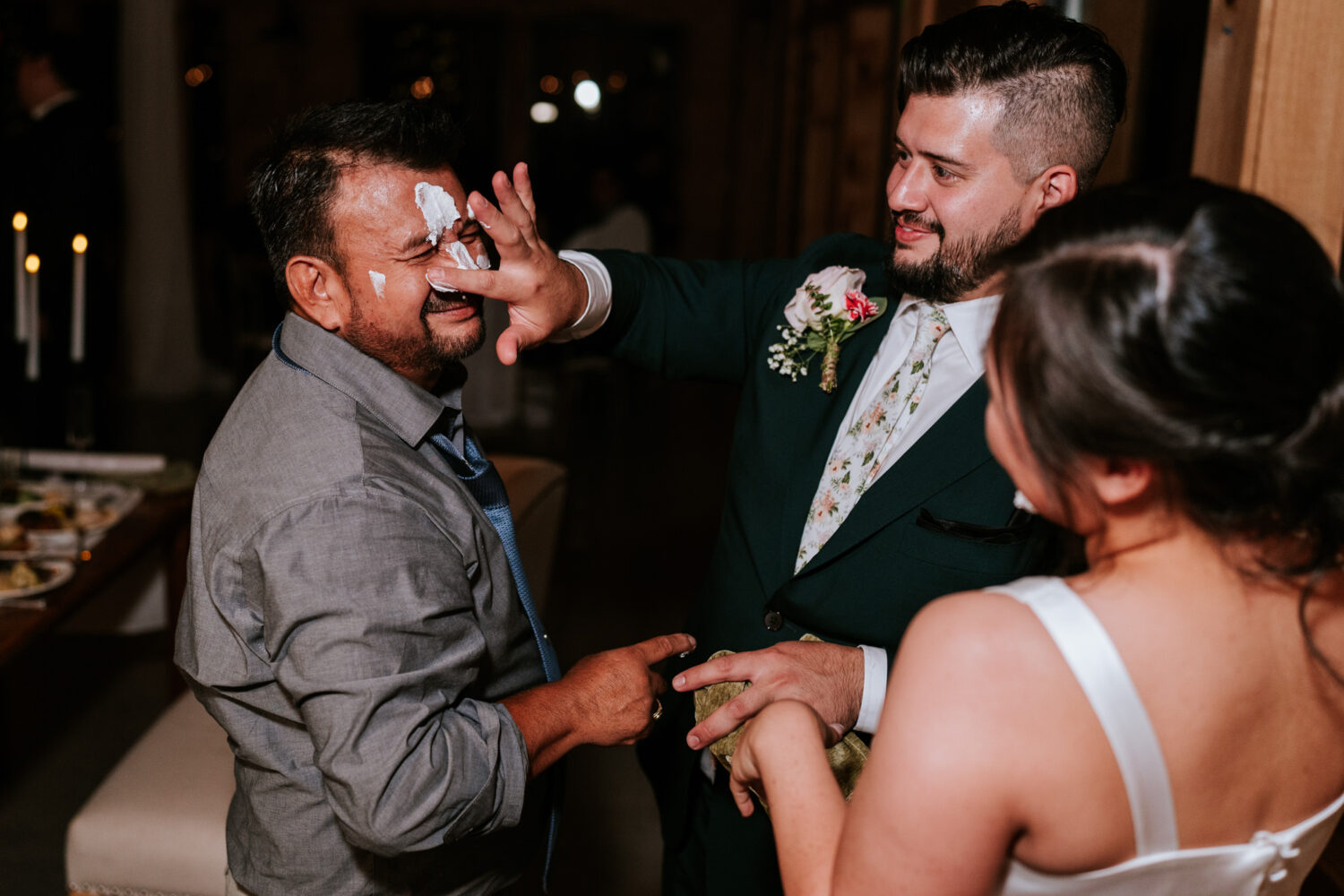 uncle of the groom and the groom out cake on each others faces