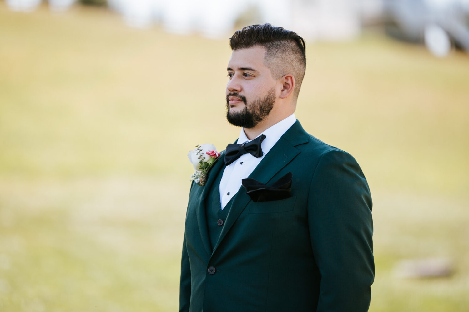groom standing still waiting to see his bride for the first time on their wedding day