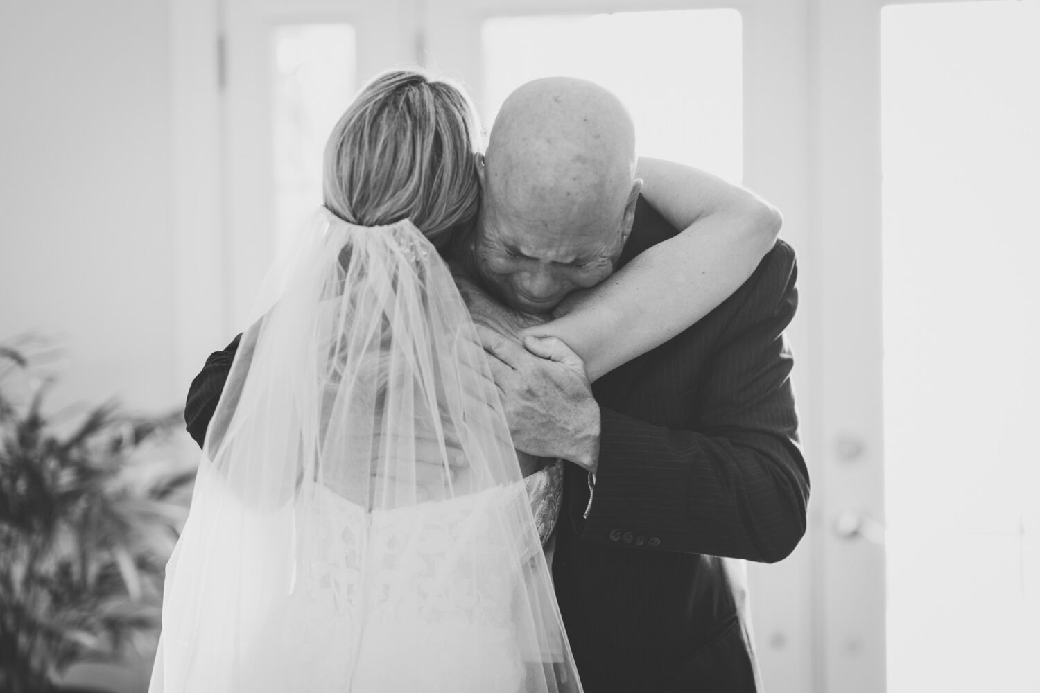 bride and her father sharing an emotional hug during the brides wedding day at the pavilion at weatherly