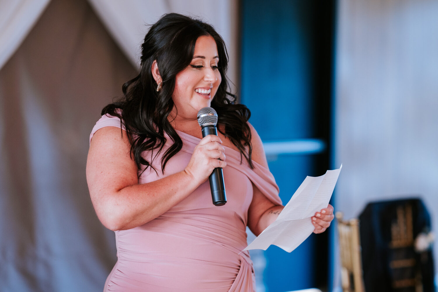 maid of honor smiling while giving her wedding speech