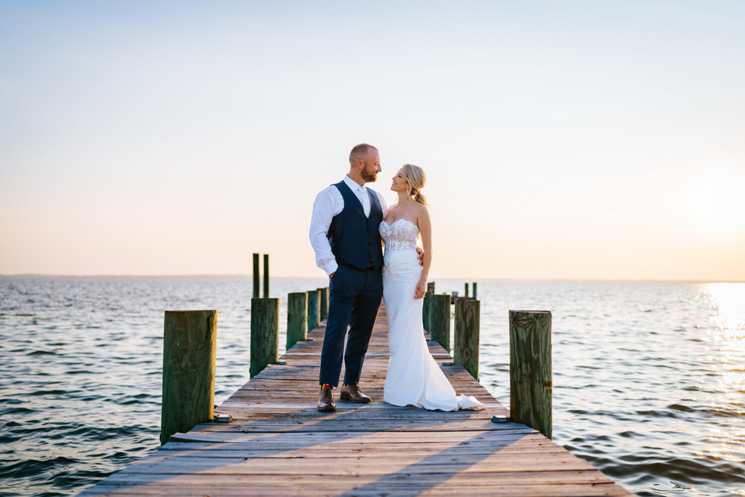 bride and groom looking at each other while on a dock by the potomac river at the pavilion at weatherly