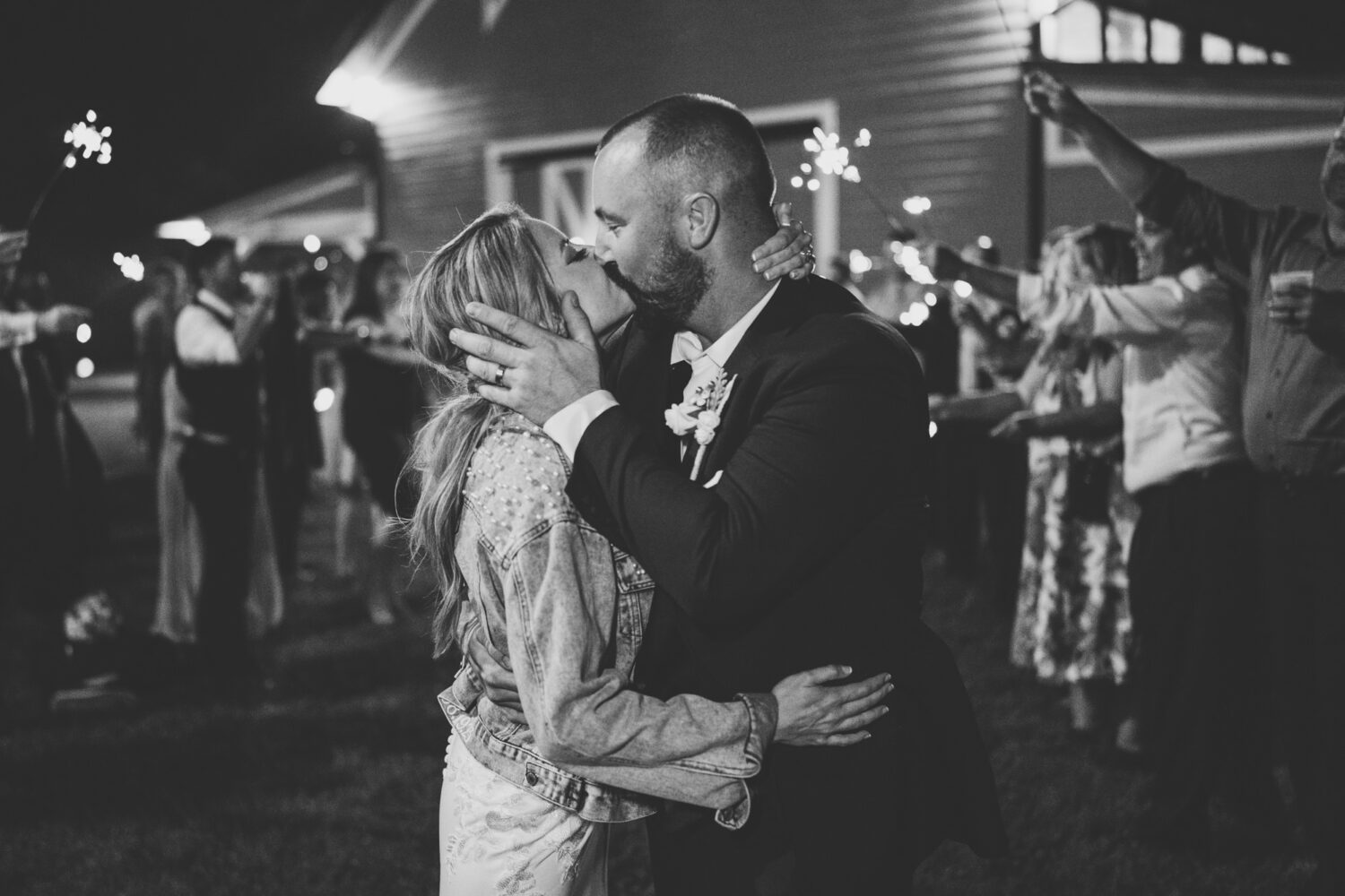bride and groom sharing a kiss during their sparkler exit on their wedding day
