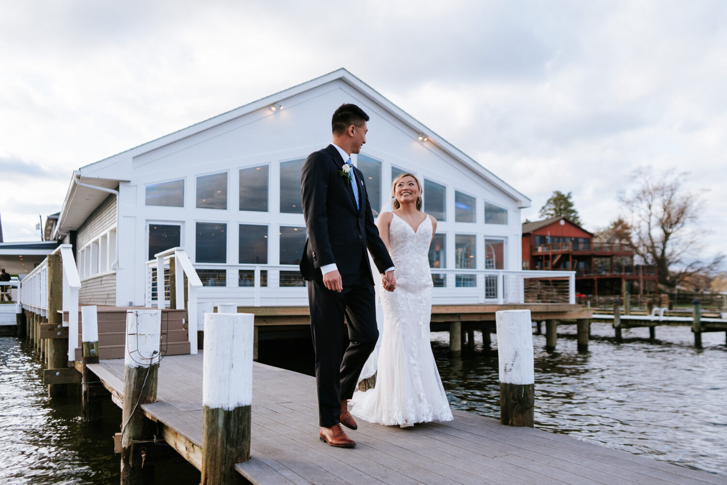 bride and groom walking in front of their wedding venue on their wedding day at anchor inn