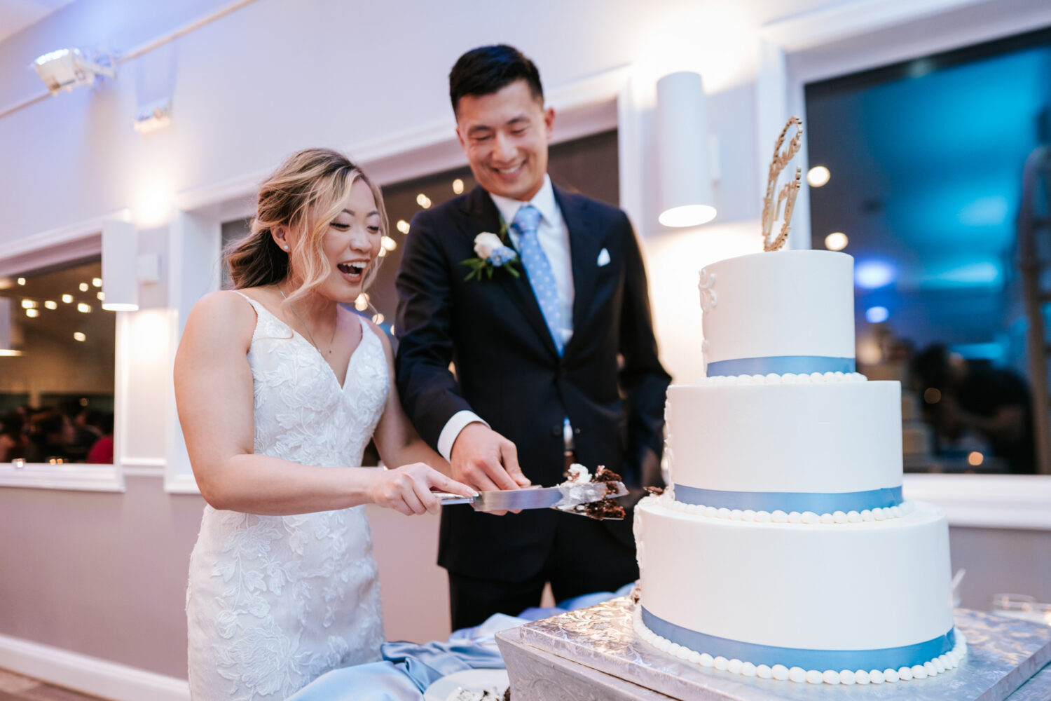 bride and groom cutting their wedding cake together during their anchor inn wedding day