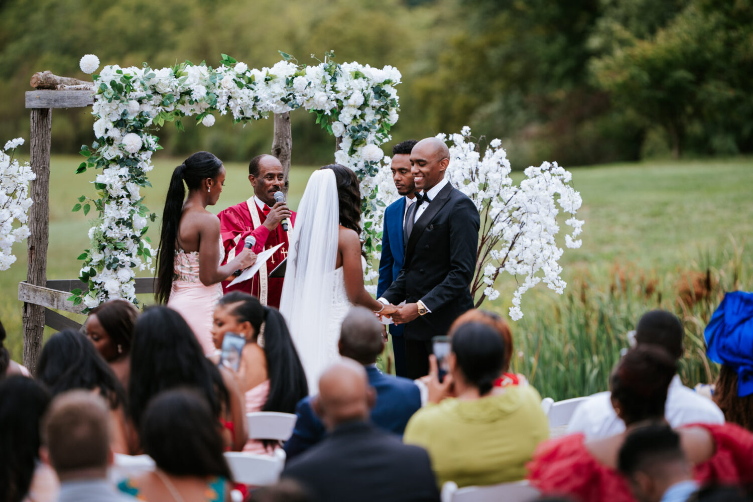 groom smiling at bride during their outdoor wedding ceremony in Leesburg, Virginia 