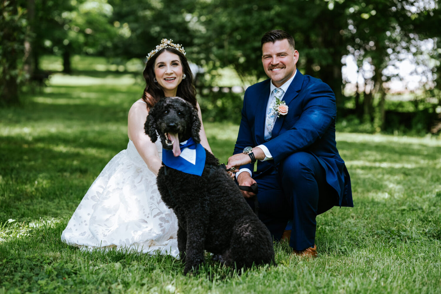 bride and groom portrait with their labradoodle dog