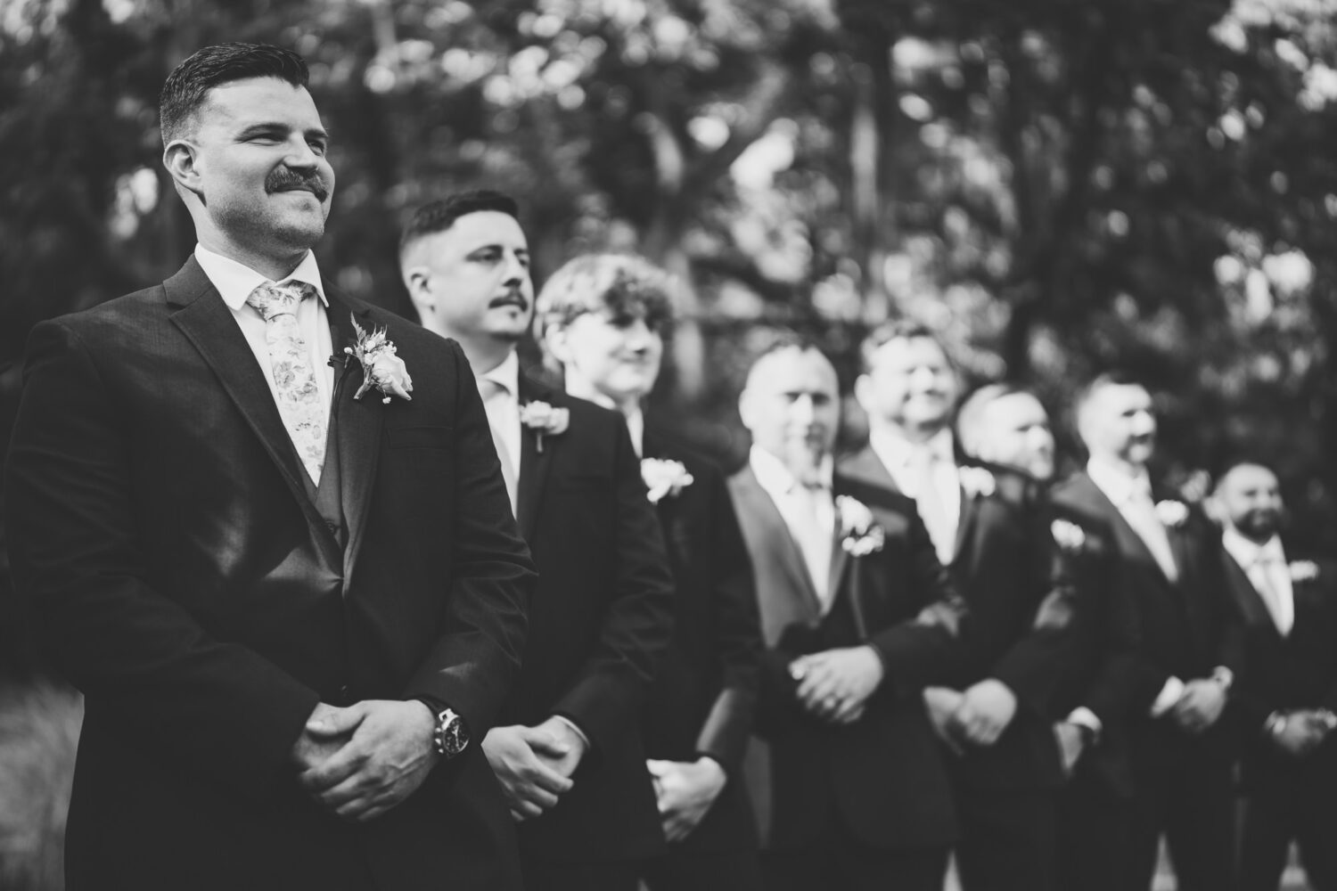 groomsmen reacting to seeing the bride walk down the aisle