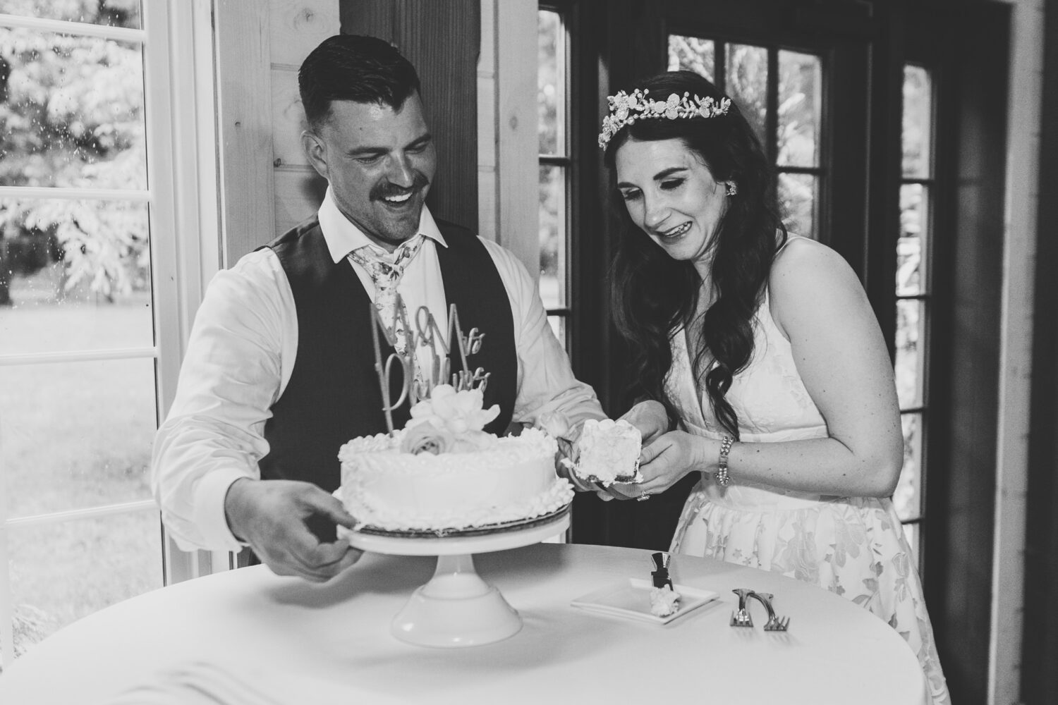 bride and groom cutting cake on their wedding day
