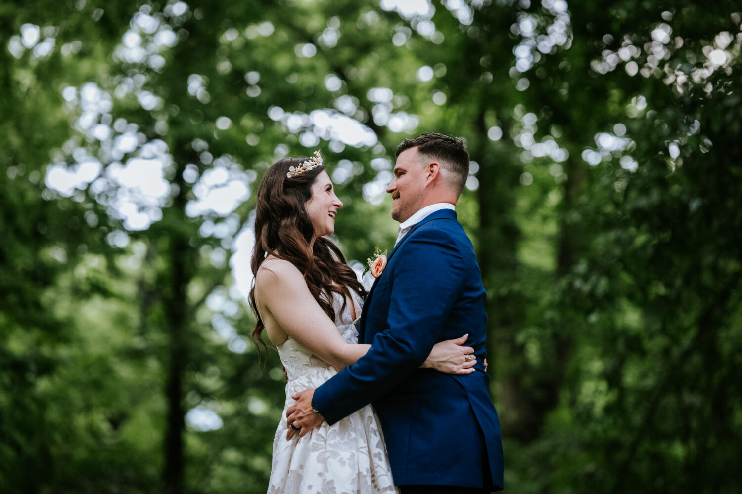 bride and groom portrait with trees in the background during their historic rosemont springs wedding
