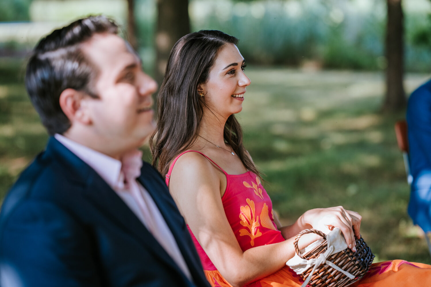 wedding guest smiling during wedding ceremony