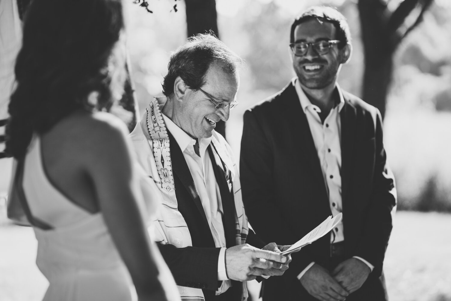 father of the groom officiating his son's backyard wedding