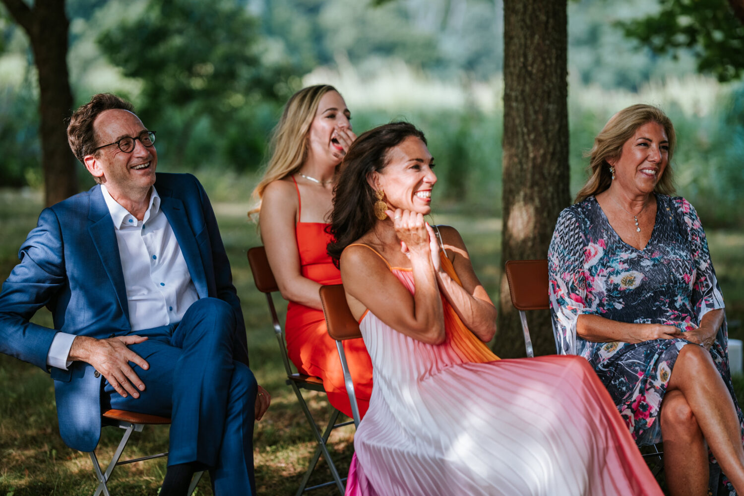 guests laughing while listening to a wedding speech