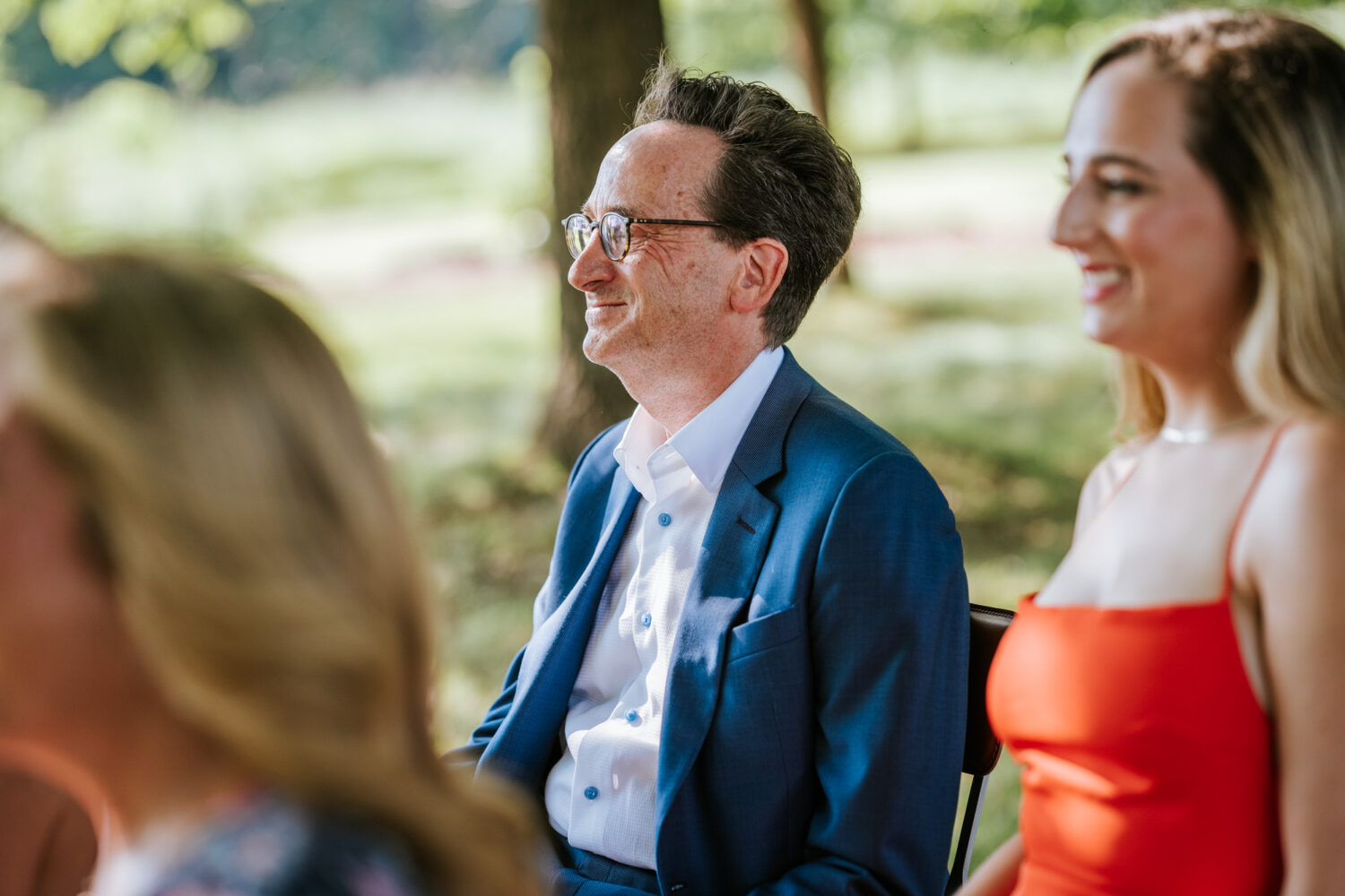 father of the bride smiling during wedding ceremony