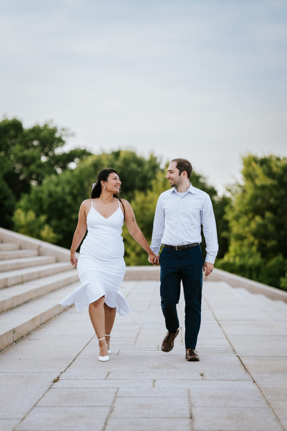 couple walking together and laughing while holding hands