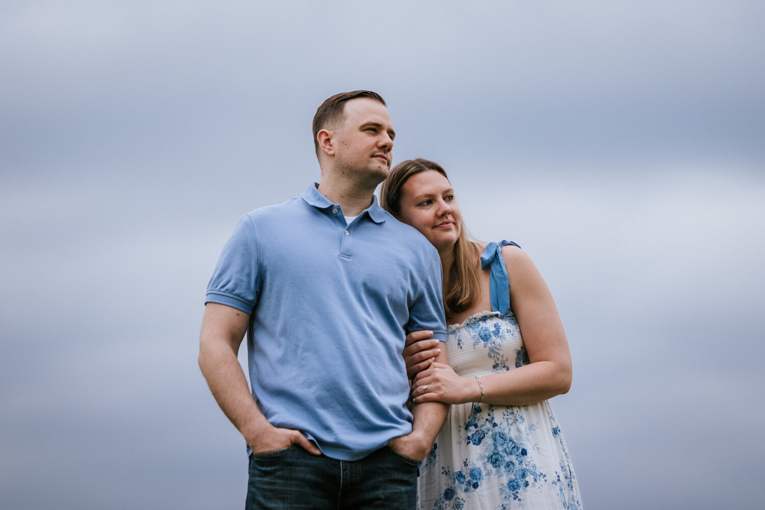 couple hugging each other with blue skies in the background
