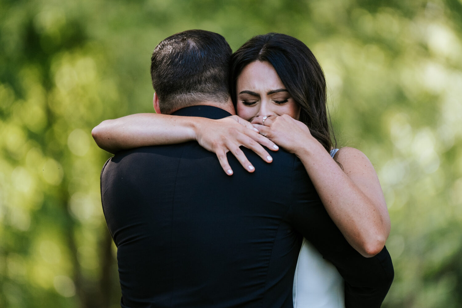 bride and groom share an emotional hug after seeing each other for the first time on their wedding day