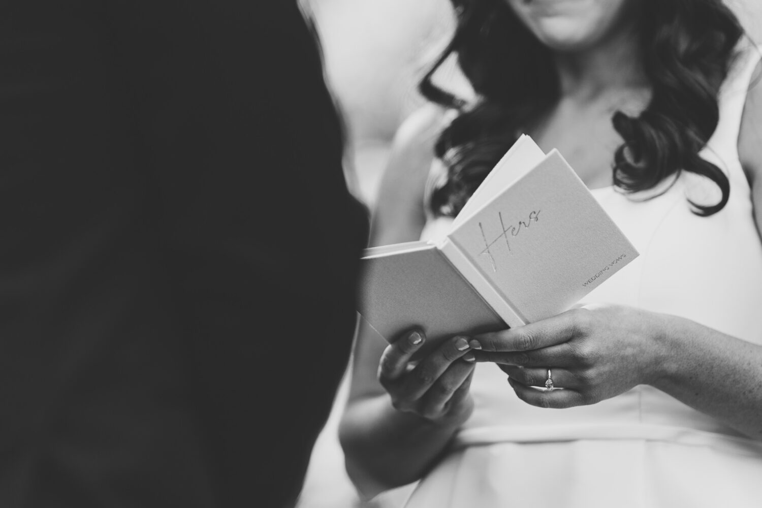 tight shot of the bride's vow book as she is sharing her private vows