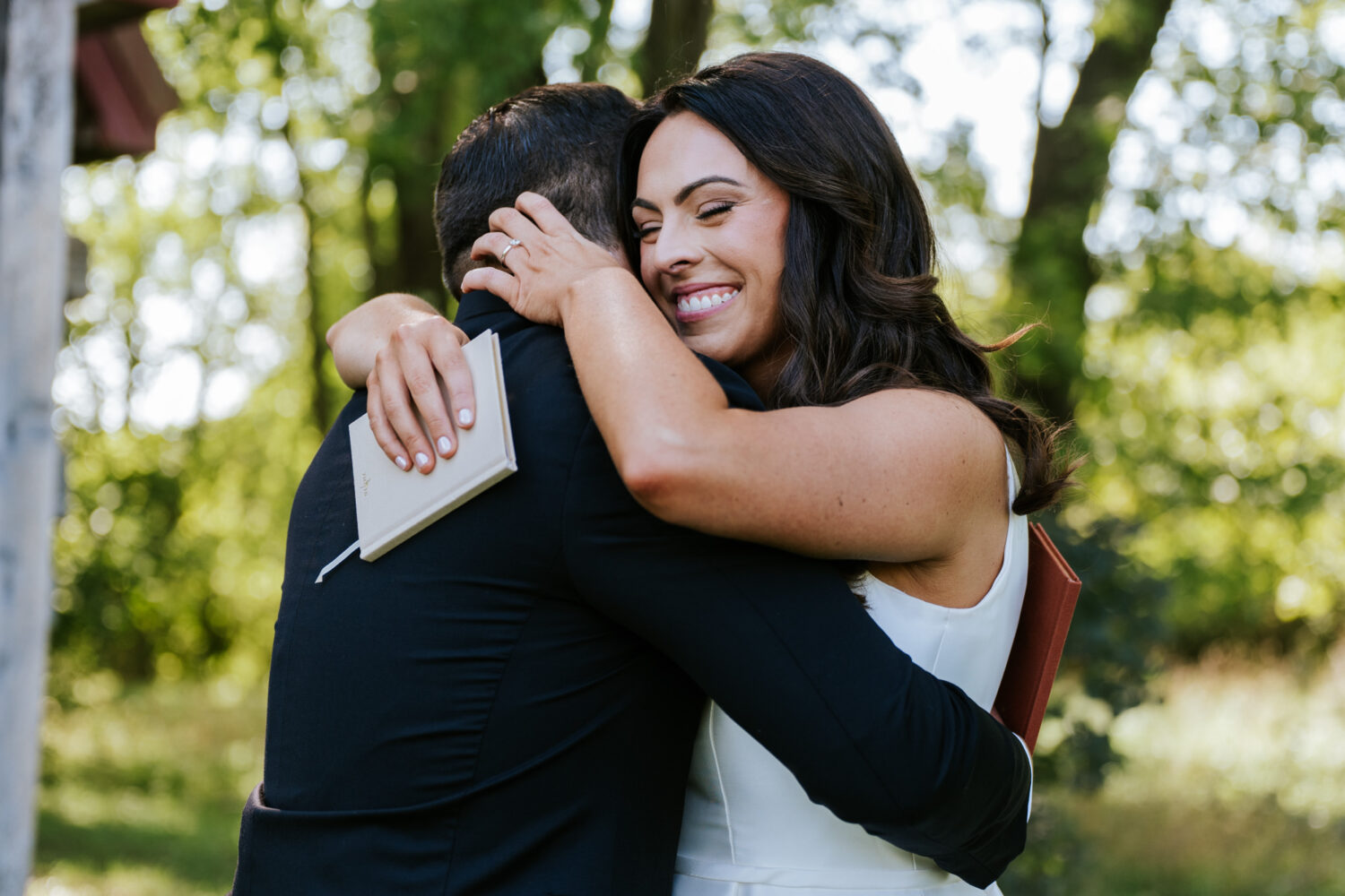 bride and groom share an emotional hug after sharing private vows