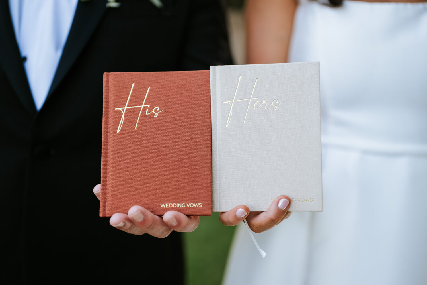 tight shot of the bride and groom's vow books