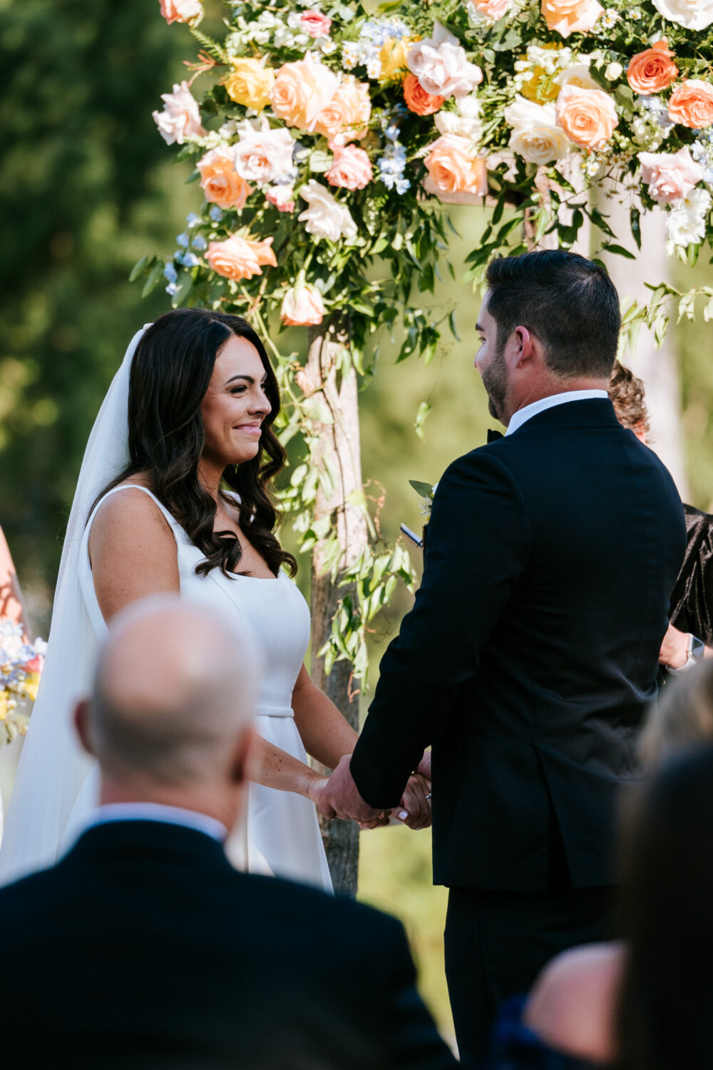 bride smiling while looking at her groom during their wedding ceremony