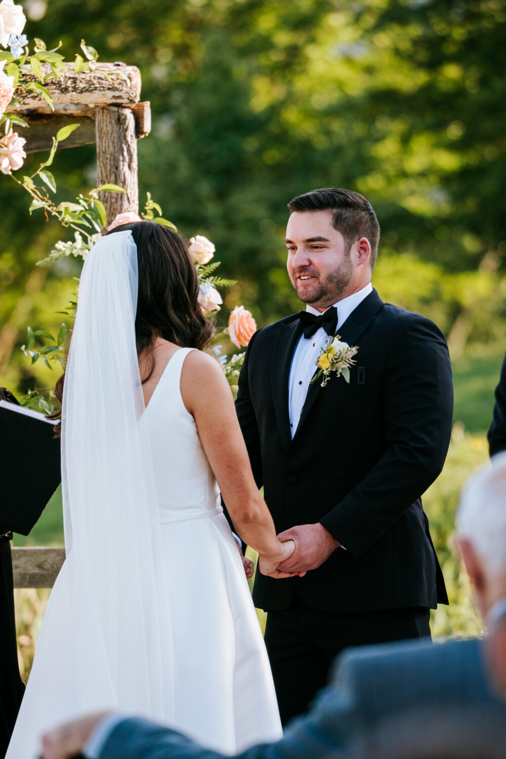 groom smiling at his bride during their wedding ceremony