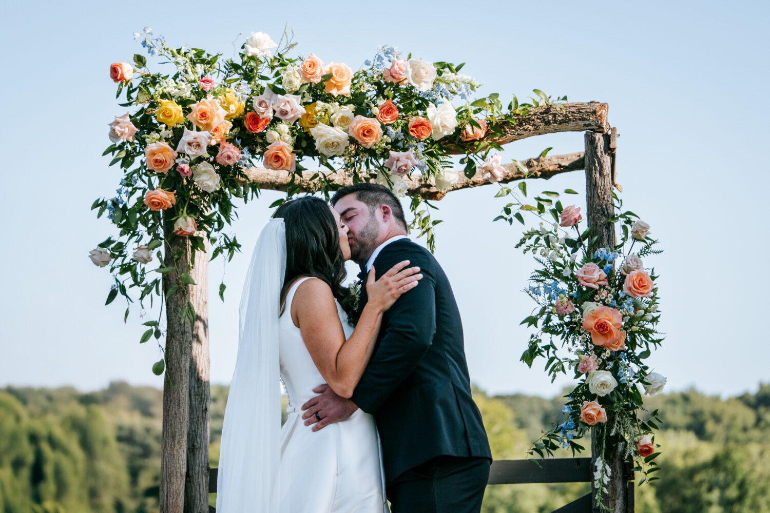 bride and groom doing their first kiss at the end of their wedding ceremony