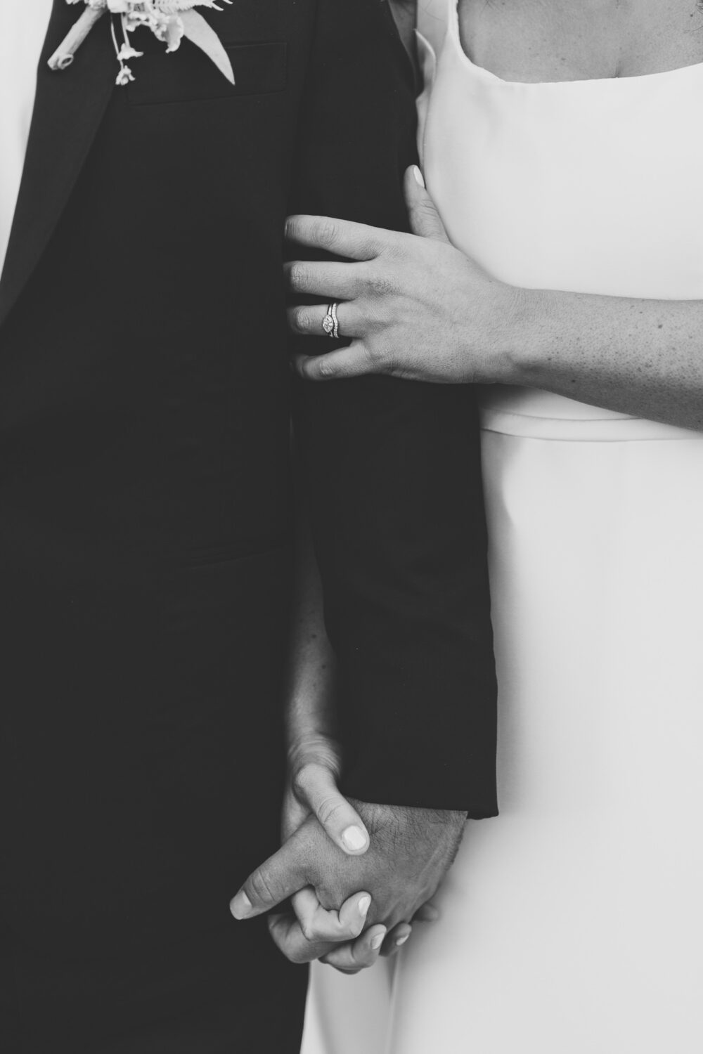 bride and groom holding hands on their wedding day