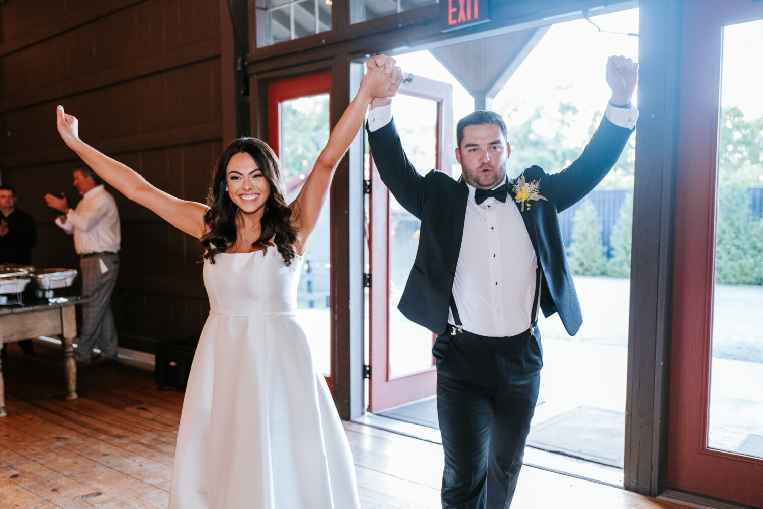 bride and groom entering their wedding reception