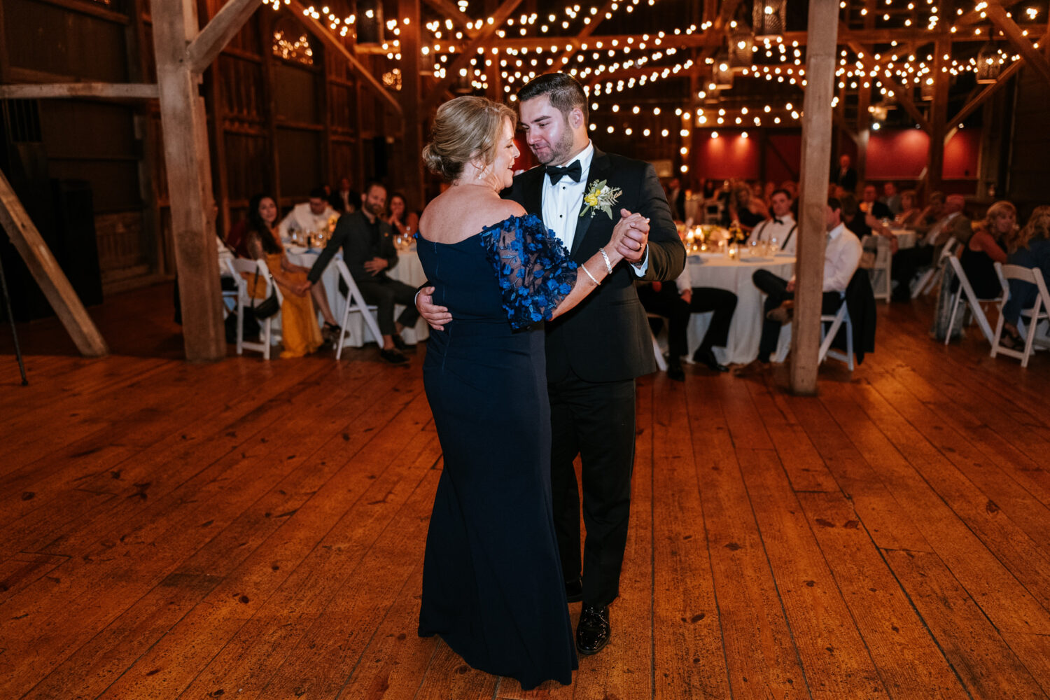 mother of the groom dancing with her son on his wedding day