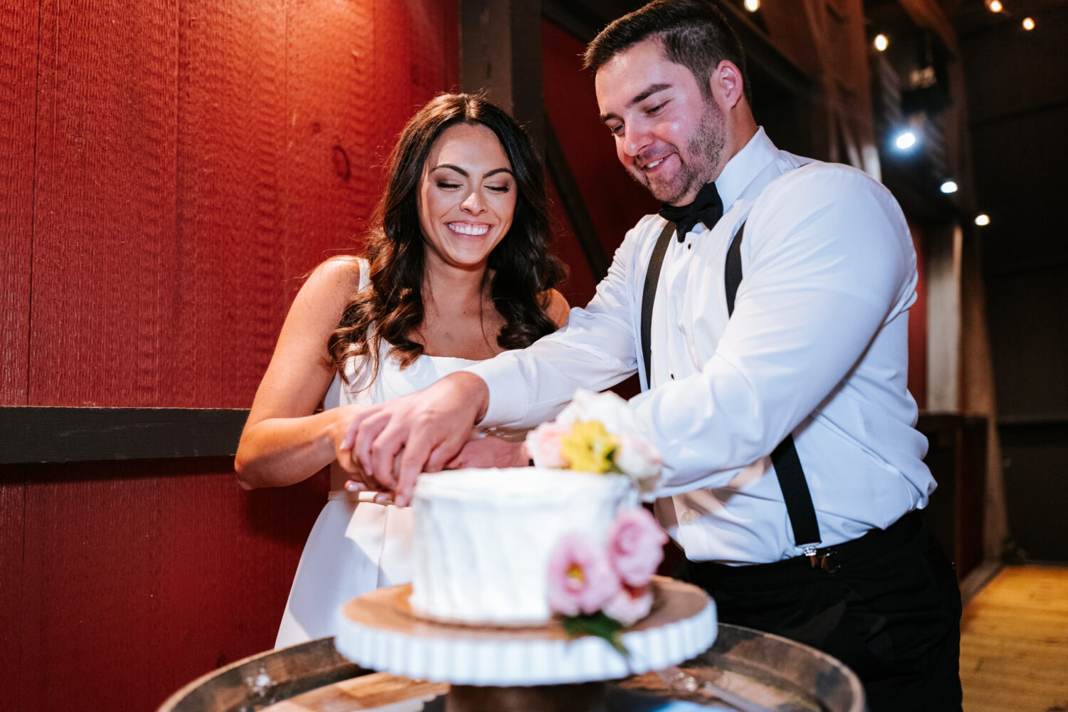 bride and groom cutting their wedding cake on their wedding day