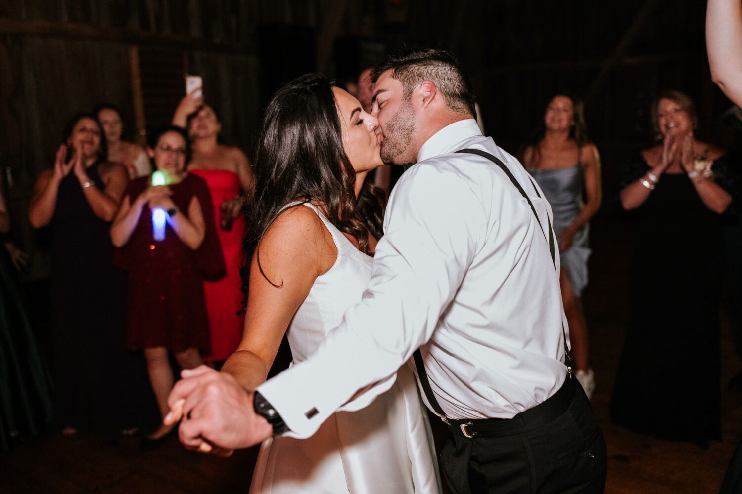 bride and groom sharing a final kiss on the dance floor