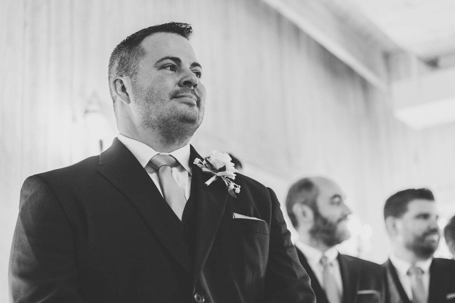 groom reacting to seeing his bride walk down the aisle on their Sweeney Barn wedding day