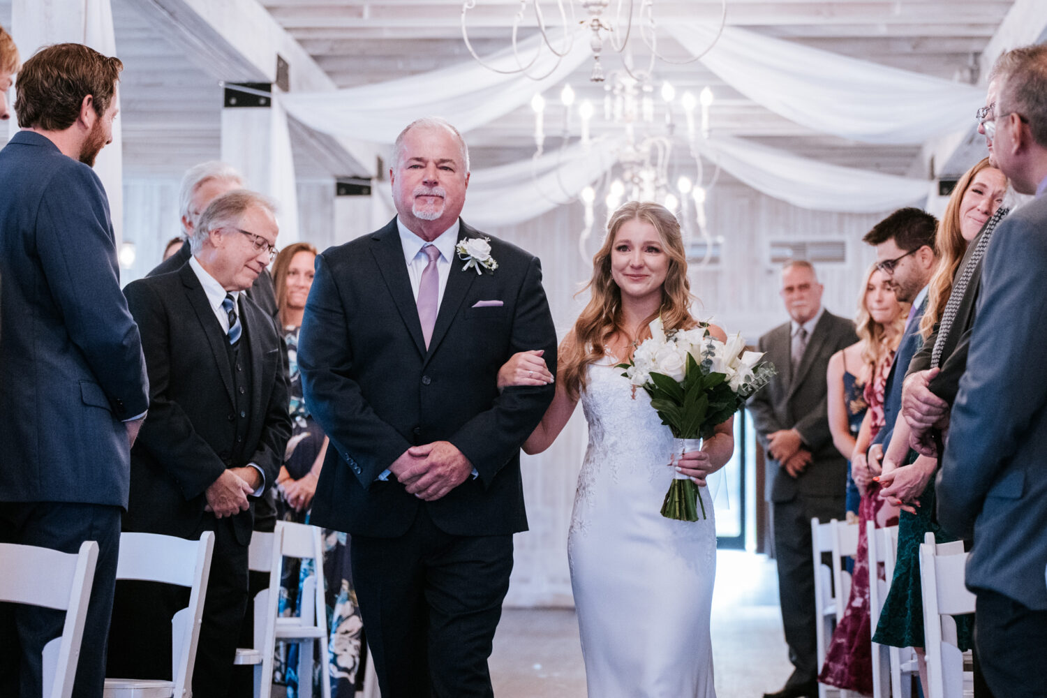 bride walking down the aisle with her father on her Sweeney Barn wedding day