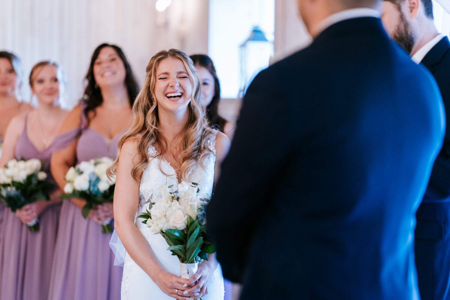 bride laughing during her wedding ceremony at Sweeney Barn in Manassas