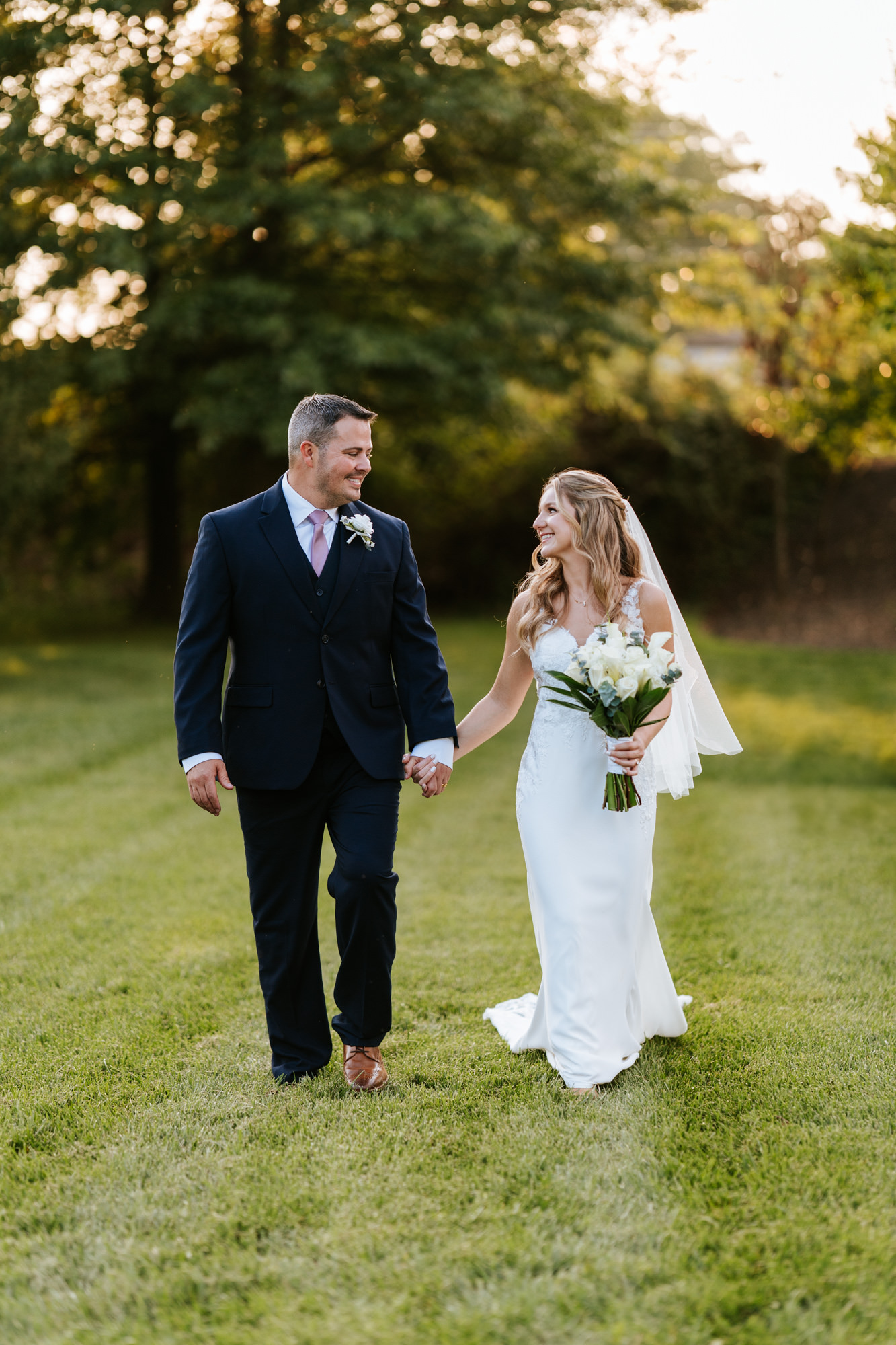 bride and groom walking together during their Sweeney Barn wedding day