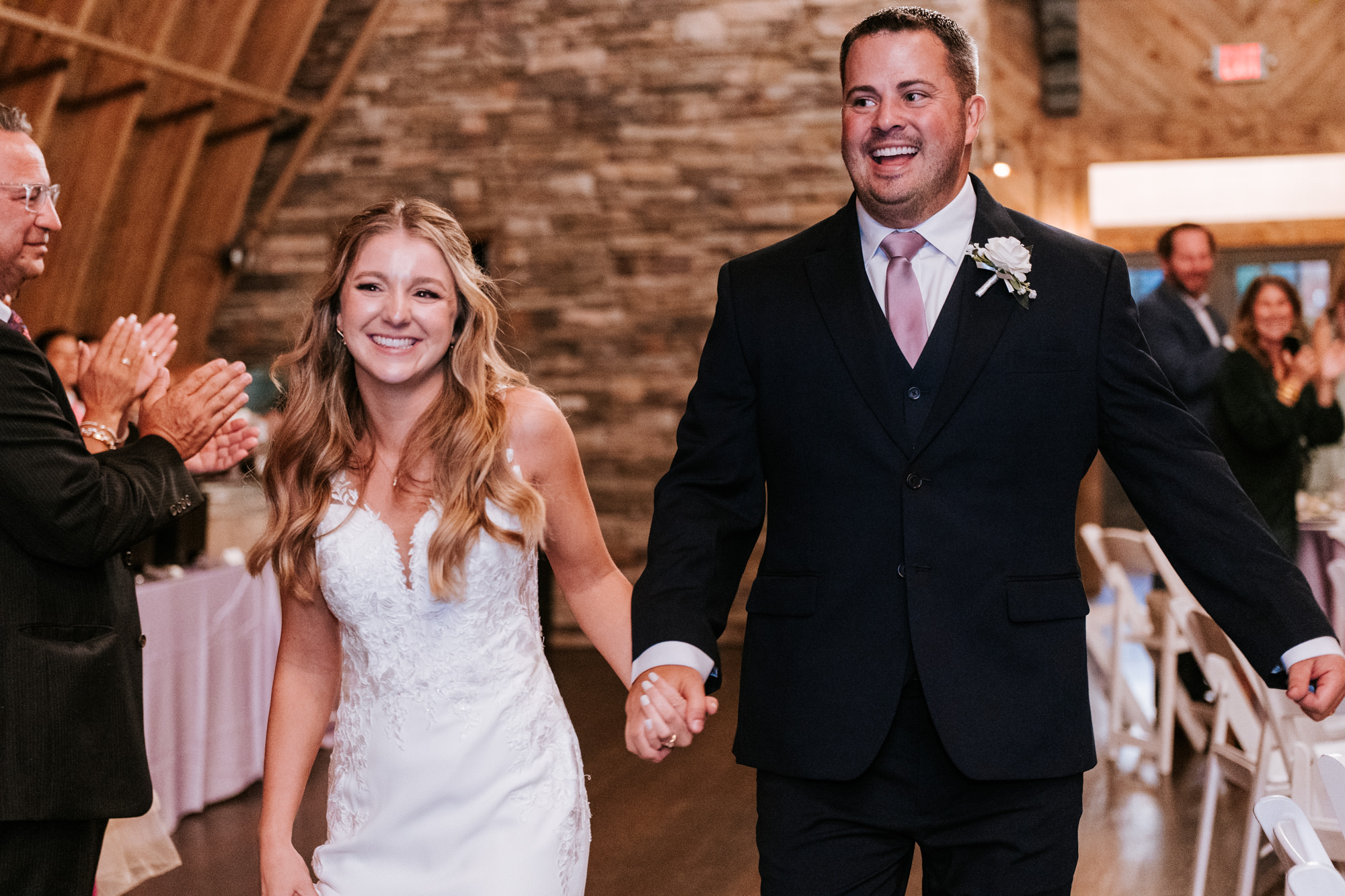 bride and groom entering their Sweeney Barn wedding day reception