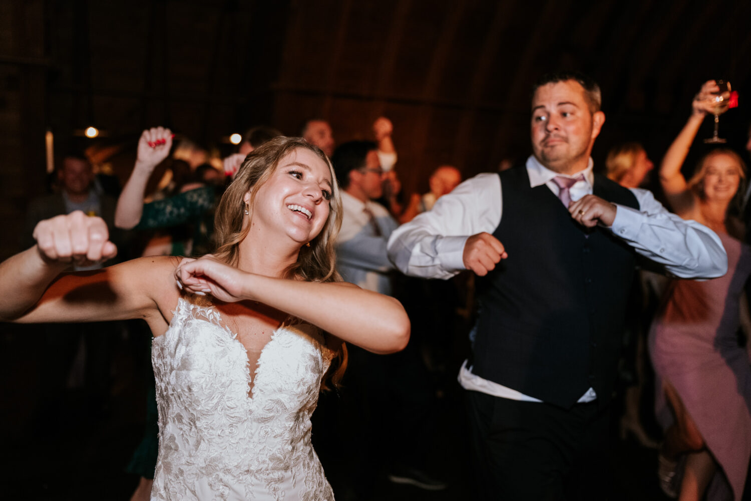 bride and groom having fun on the dance floor together 