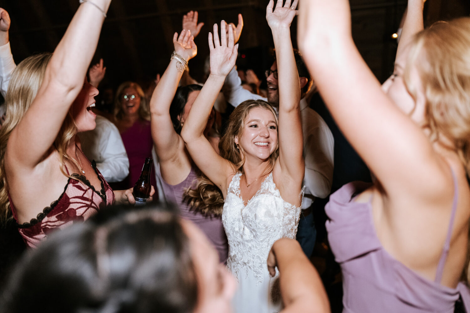 bride having fun with her wedding guests during her Sweeney Barn wedding day