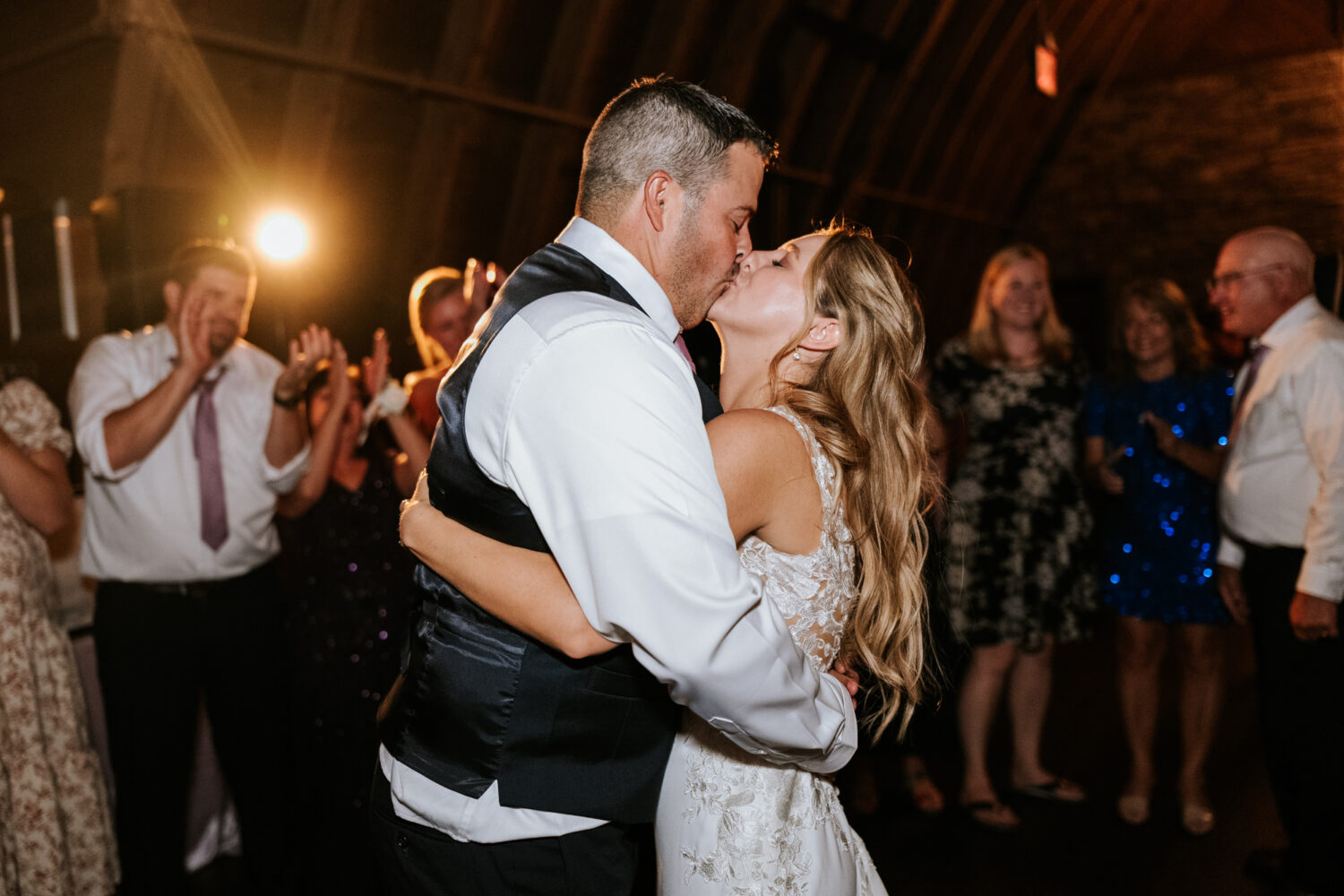 bride and groom sharing a kiss on the dance floor 