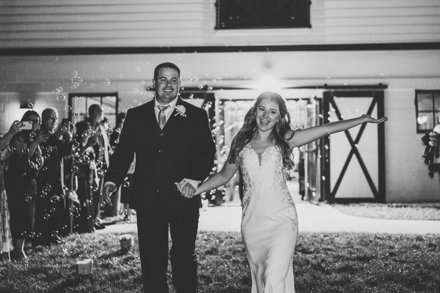 bride and groom leaving their Sweeney Barn wedding day with a sparkler exit