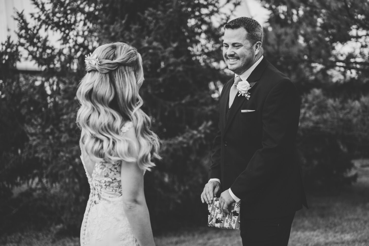 groom reacting with a big smile after seeing his bride for the first time on their wedding day