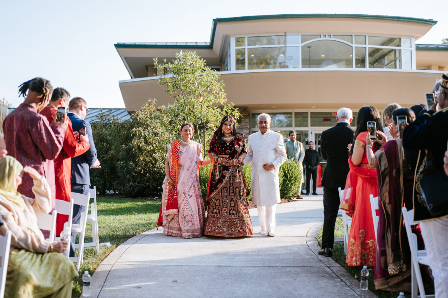 bride walking down the aisle during her indian wedding day