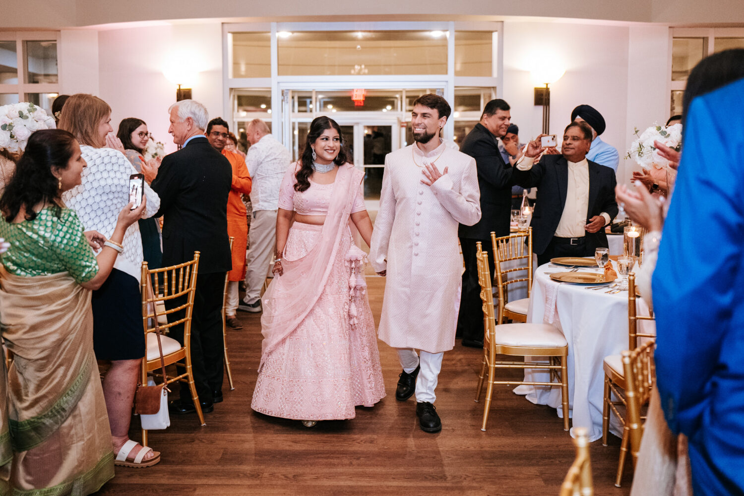 bride and groom entering their woodlands wedding reception