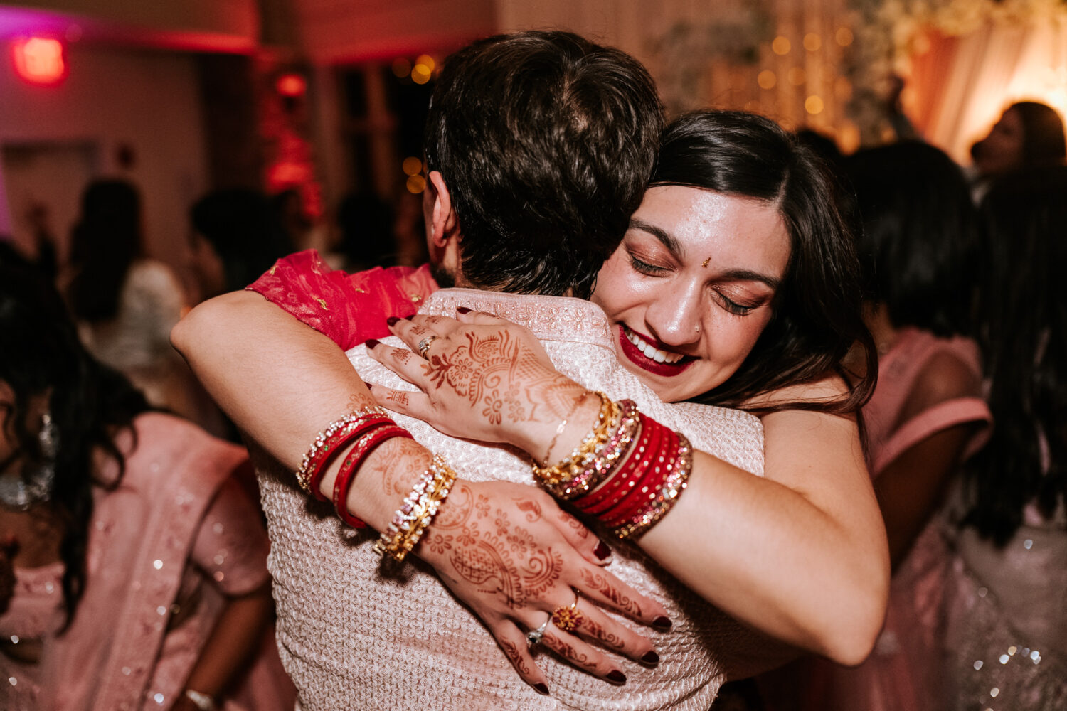 guest hugging the groom on the dance floor