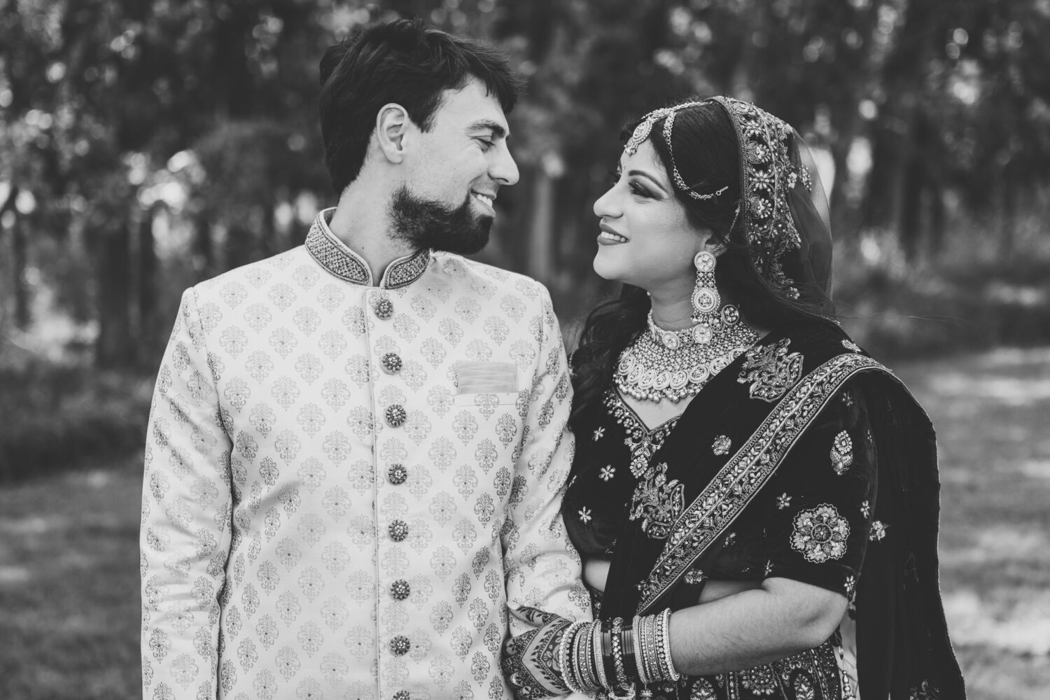 bride and groom smiling together on their woodlands wedding day 